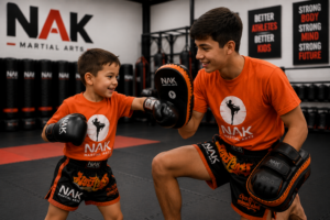 KIDZ Kickboxing athlete training with an older Youth Muay Thai athlete